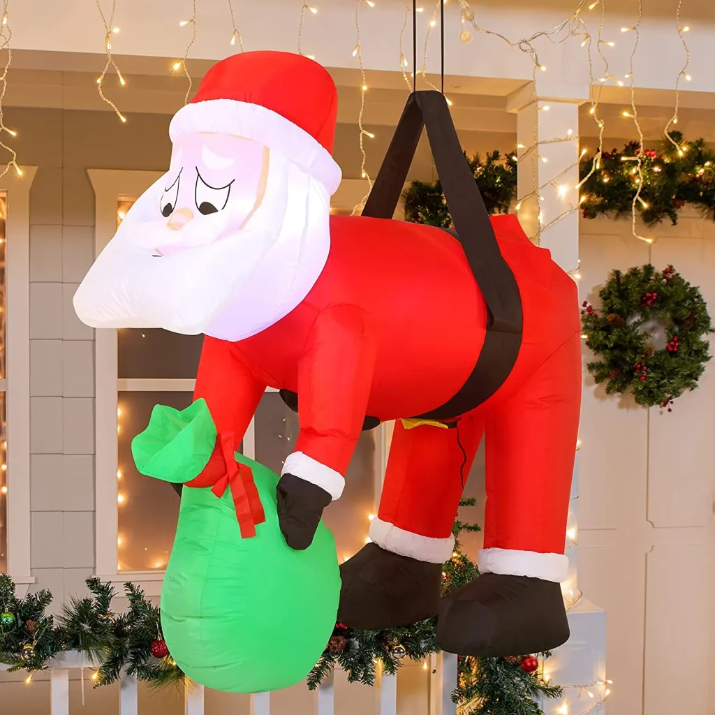 Inflatable santa hung on a tree