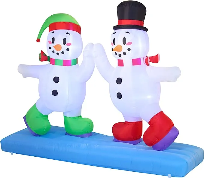 Giant christmas inflatables high five snowman ice skating