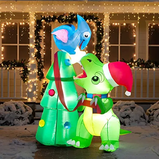Dinosaur decorating an inflatable christmas tree