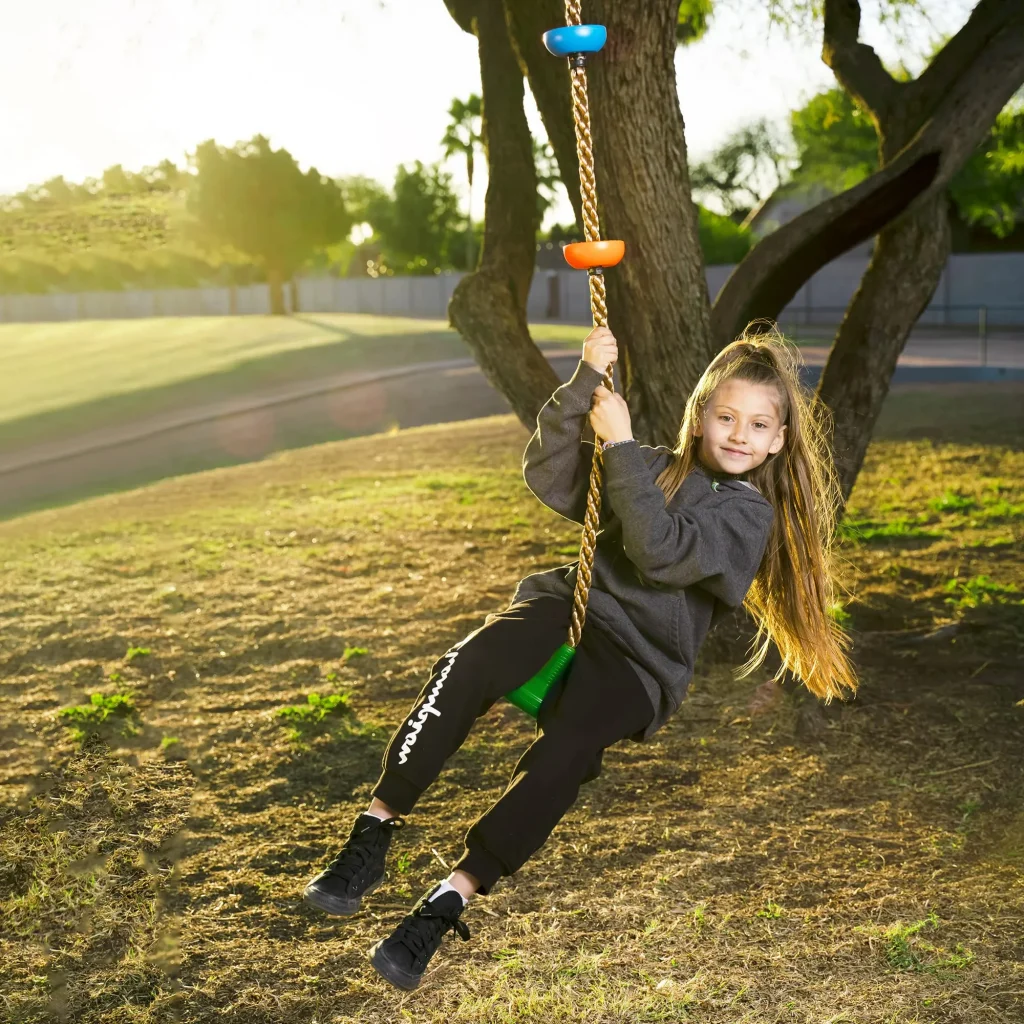 Green climbing rope tree swing with platforms